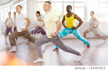 European guy with team of like-minded multinational people learn to elements of hip hop dance European guy with team of like-minded multinational people learn to elements of hip hop dance 118162913
