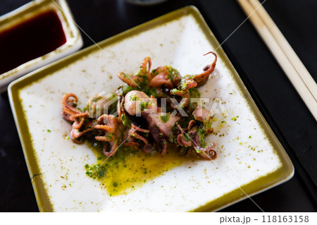 Small fried octopus with soy sauce. Japanese dish close up Small fried octopus with soy sauce. Japanese dish close up 118163158