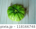 green pumpkin on white wooden background 118166748