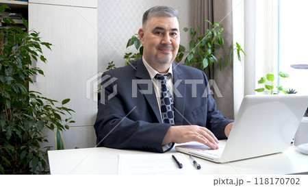 Confident Businessman in Suit Smiling at the Camera 118170702