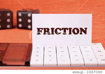 Friction concept. Friction word on a white business card on the calculator, front view 118171393