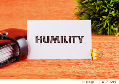 Lifestyle concept. HUMILITY word on a white card on an orange background, close-up, front view 118171394