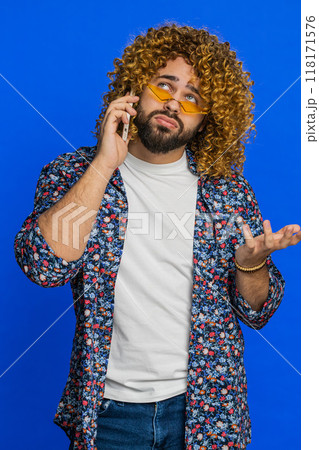 Disinterested tired stylish man having annoyed boring talk on smartphone online conversation quarrel 118171576