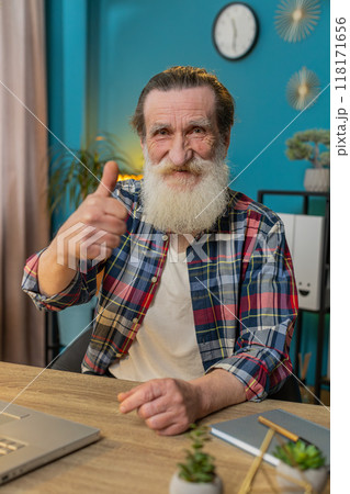 senior man looking approvingly at camera showing thumbs up like sign positive feedback good news senior man looking approvingly at camera showing thumbs up like sign positive feedback good news 118171656
