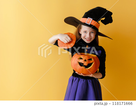 girl in witch costume with Halloween pumpkin girl in witch costume with Halloween pumpkin 118171666