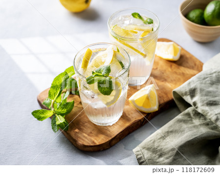 Lemonade drink with fresh lemons, lime, mint and ice. Refreshing citrus mojito cocktail 118172609