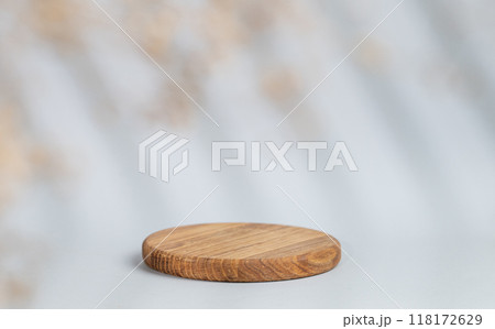 Abstract empty wooden board with shadows leaves on a gray background. Abstract empty wooden board with shadows leaves on a gray background. 118172629