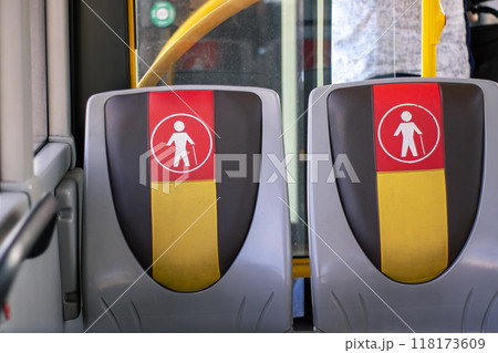 Two seats are available on a bus with a man using a cane Two seats are available on a bus with a man using a cane 118173609