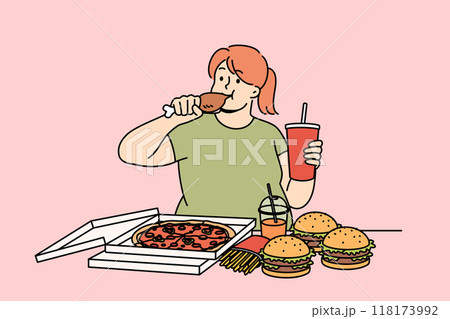 Young woman eats fast food and drinks soda, becoming addicted to harmful calories 118173992
