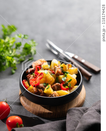 Fried pork meat with potatoes, onions and peppers. National homemade Georgian dish ojakhuri Fried pork meat with potatoes, onions and peppers. National homemade Georgian dish ojakhuri 118174428