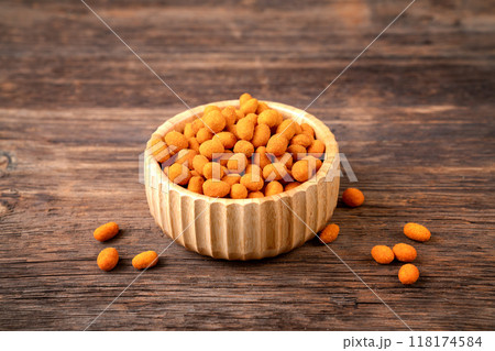 Peanut chips with sauce in bowl on old wooden table stock photo 118174584