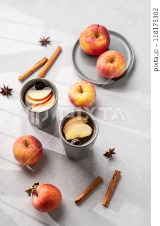 Homemade apple punch with apples and cinnamon in cups on a light background with fresh fruits Homemade apple punch with apples and cinnamon in cups on a light background with fresh fruits 118175302