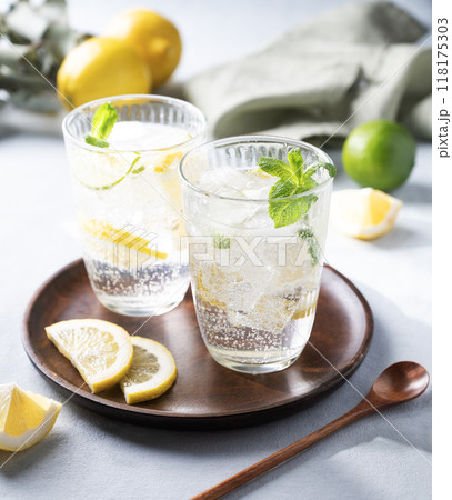 Lemonade drink with fresh lemon, lime, mint and ice. Refreshing citrus mojito cocktail Lemonade drink with fresh lemon, lime, mint and ice. Refreshing citrus mojito cocktail 118175303