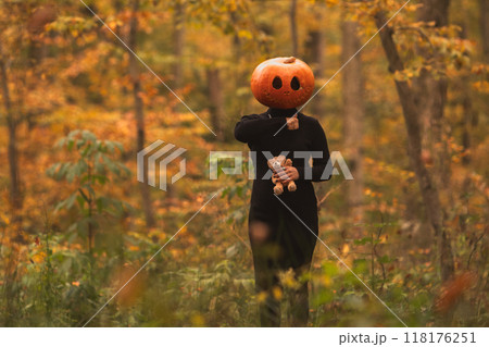 Surreal Pumpkin Head in Autumn Forest 118176251