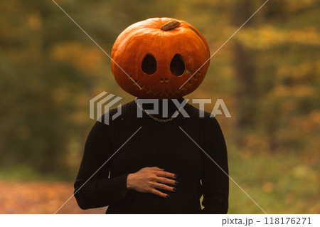 Person in Pumpkin Costume in Autumn Forest 118176271