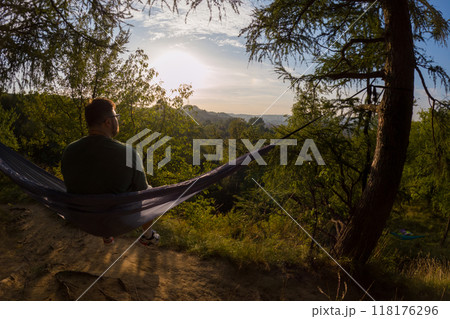 Relaxing in a Hammock at Sunset 118176296