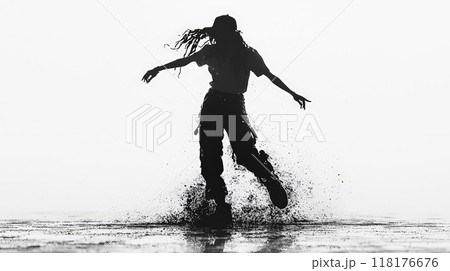 A striking black silhouette captures a street dancer mid-performance, frozen in a dynamic pose. Generative AI	 118176676