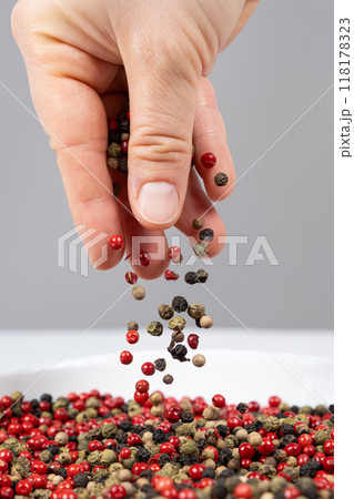 Hand sprinkling peppercorn mixture red, green, white and black pepper 118178323