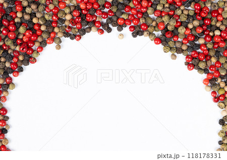 Frame of different varieties of peppercorns on a white background, top view, place for text. 118178331