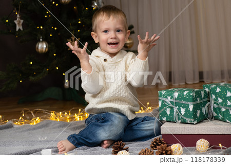 Little two-year-old boy opens Christmas gifts at home Little two-year-old boy opens Christmas gifts at home 118178339