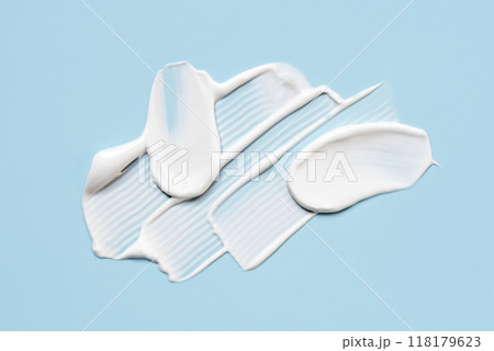 Smear of cream on a blue background. 118179623