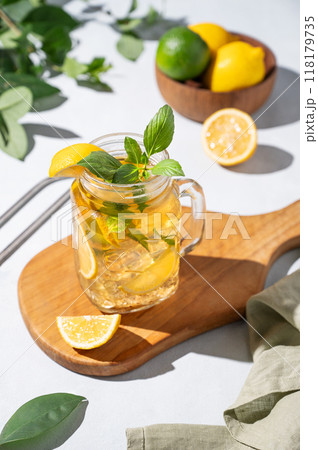 Lemonade drink or cold tea with fresh lemon, mint and ice in jar. Refreshing citrus mojito cocktail 118179735