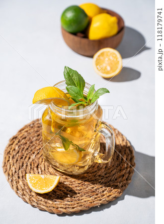 Lemonade drink or cold tea with fresh lemon, mint and ice in jar. Refreshing citrus mojito cocktail 118179741