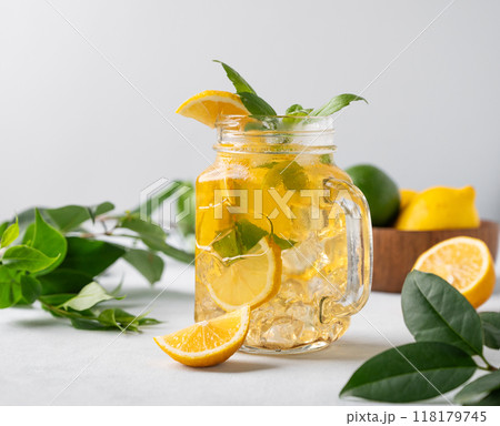 Lemonade drink or cold tea with fresh lemon, mint and ice in  jar. Refreshing citrus mojito cocktail 118179745