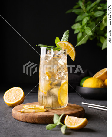Lemonade drink with fresh lemon, mint and ice. Refreshing citrus mojito cocktail on a wooden board Lemonade drink with fresh lemon, mint and ice. Refreshing citrus mojito cocktail on a wooden board 118179770