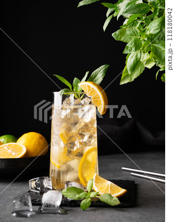 Lemonade drink with fresh lemon, lime, mint and ice. Refreshing citrus mojito cocktail  118180042