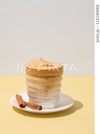 Vegetarian dalgona coffee. Whipped instant iced coffee with soy milk in a glass with cinnamon 118180068