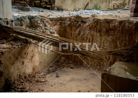 Large pile of earth in which there are many metal reinforcement bars Large pile of earth in which there are many metal reinforcement bars 118180353