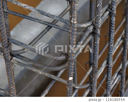A construction site displaying a reinforced concrete foundation with steel rebar 118180554