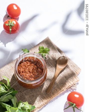 Homemade tomato sauce is an appetizer with tomatoes and hot peppers in a jar Homemade tomato sauce is an appetizer with tomatoes and hot peppers in a jar 118180795