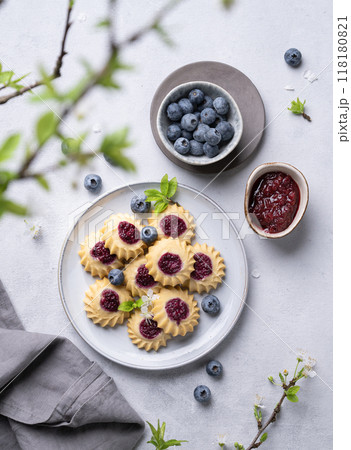 Homemade kurabye cookies with berry filling on a blue background with blueberries and jam. Homemade kurabye cookies with berry filling on a blue background with blueberries and jam. 118180821
