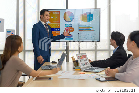 Group of business people are gathered in a meeting room, discussing and sharing ideas around a large conference table. Group of business people are gathered in a meeting room, discussing and sharing ideas around a large conference table. 118182321