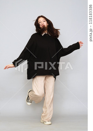 Girl in a black hoodie stands poised, the front clear for prints. Use this as a mockup for your logo or artwork. Girl in a black hoodie stands poised, the front clear for prints. Use this as a mockup for your logo or artwork. 118183386