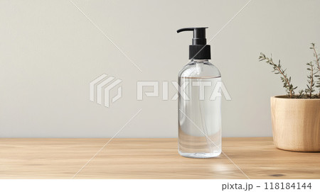 A minimalist water bottle on grey background and beautifully arranged greenery 118184144