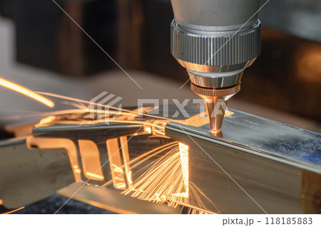 Close up scene the fiber laser cutting machine cut the square shape stainless steel tube with sparkling light. Close up scene the fiber laser cutting machine cut the square shape stainless steel tube with sparkling light. 118185883