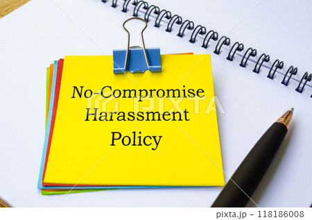 No compromise harassment policy text written on yellow sticky note. Protection at workplace concept 118186008