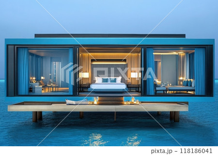 Experience the magic of a secluded overwater villa in the Maldives, where golden lights glow softly within elegant interiors as the sun sets over the tranquil ocean waters. 118186041