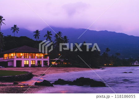 As twilight envelops the landscape, a cozy honeymoon resort sits by the shore, its warm lights reflecting on the gentle waves. The serene ambiance invites couples to relax and embrace intimacy. As twilight envelops the landscape, a cozy honeymoon resort sits by the shore, its warm lights reflecting on the gentle waves. The serene ambiance invites couples to relax and embrace intimacy. 118186055