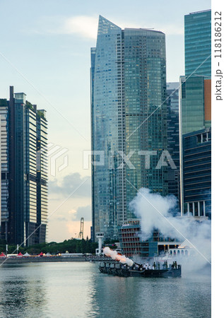 A naval cruiser firing a large artillery cannon in Singapore's M 118186212