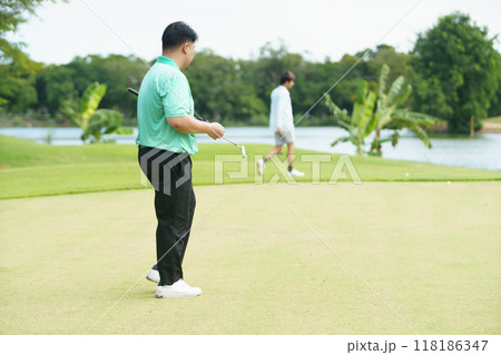 Man is playing golf in morning. 118186347