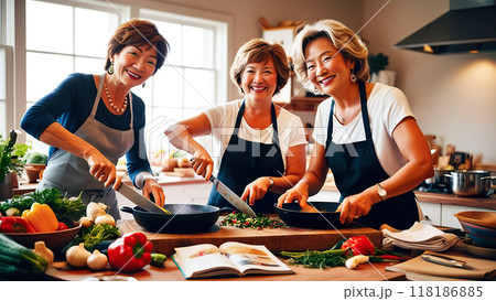 Three joyful elderly women in aprons cooking together in a bright kitchen, enjoying the process and each other's company. 118186885