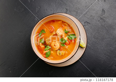 Spicy Thai Authentic Tom Yum soup with shrimp, mushrooms, and herbs, perfect for culinary projects 118187178