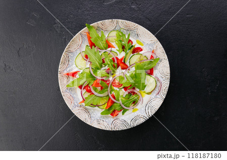 Colorful fresh salad with arugula, cucumbers, and tomatoes - a perfect dish for healthy eating Colorful fresh salad with arugula, cucumbers, and tomatoes - a perfect dish for healthy eating 118187180
