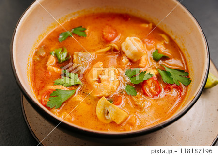 Spicy Thai Authentic Tom Yum soup with shrimp, mushrooms, and herbs, perfect for culinary projects 118187196