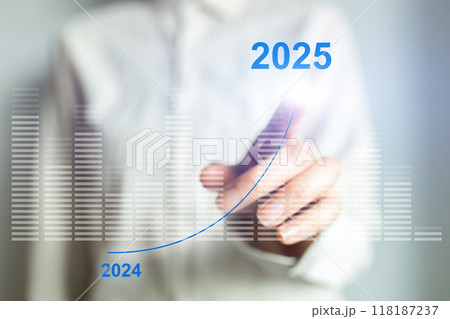 A woman is pressing a button on a computer screen that says 2025 above her han 118187237