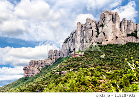Views of the Montserrat massif or mountain province of Barcelona, Catalonia, on a day with white clouds and blue sky.	 118187932